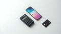 a smartphone showing a tax app beside a calculator and credit card