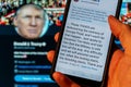 Smartphone showing Twitter covering Trump tweet with warning label for Ã¢â¬Åglorifying violence Royalty Free Stock Photo