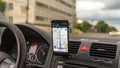 Smartphone showing Waze maps to show the way thru the city