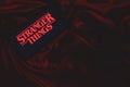 Smartphone with the Stranger Things logo. Stranger Things Royalty Free Stock Photo