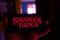 Smartphone with the Stranger Things logo. Stranger Things Royalty Free Stock Photo