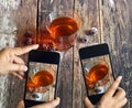 Smartphone take photos of tea and grape on wooden background, vibrant concept