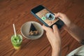 Smartphone take shot chocolate cake and iced green lemonade photo.