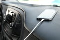 Smartphone with USB charging cable in modern car Royalty Free Stock Photo