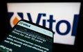 Smartphone with website of Dutch trading company Vitol Holding B.V. on screen in front of business logo.