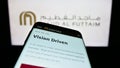 Smartphone with website of Emirati company Majid Al Futtaim Group on screen in front of business logo.