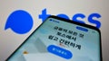 Smartphone with website of South Korean fintech Viva Republica Co Ltd. (Toss) on screen in front of logo.