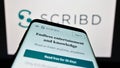 Smartphone with website of US publishing platform company Scribd Inc. on screen in front of business logo. Royalty Free Stock Photo