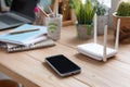 Smartphone and Wi-Fi Router on Office Desk Royalty Free Stock Photo