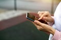 Smartphone in women`s hands close-up. Using the phone, fingers on the touch screen of the gadget. Text messages, doing business, I Royalty Free Stock Photo