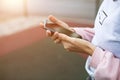 Smartphone in women`s hands close-up. Using the phone, fingers on the touch screen of the gadget. Text messages, doing business, I Royalty Free Stock Photo