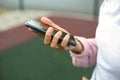 Smartphone in women`s hands close-up. Using the phone, fingers on the touch screen of the gadget. Text messages, doing business, I Royalty Free Stock Photo