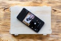 Smartphone on a wooden box with itself image on screen. Remote camera control application concept Royalty Free Stock Photo