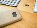 Smartphone on wooden desk.