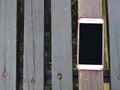 Smartphone on the wooden planks Royalty Free Stock Photo