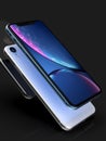 3 iPhone XR blue. silver and Space Grey smart phones on black