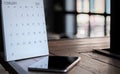 Smartphones and calendars on a dark wooden table are a creative concept Royalty Free Stock Photo