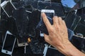 Smartphones and phone screens that are damaged by usage are gathered to be recycled for valuable minerals because e-waste contains