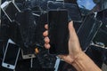 Smartphones and phone screens that are damaged by usage are gathered to be recycled for valuable minerals because e-waste contains