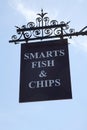 Smarts Fish and Chips sign hanging from a takeaway in the UK