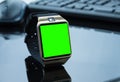 Smartwatch near computer pc keyboard and mouse with chroma key green screen Royalty Free Stock Photo