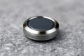 Smartwatch round button rests on gray surface Royalty Free Stock Photo