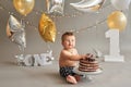 Smash cake party. Little cheerful birthday boy with first cake. Happy infant baby celebrating his first birthday. Decoration and Royalty Free Stock Photo