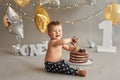 Smash cake party. Little cheerful birthday boy with first cake. Happy infant baby celebrating his first birthday. Decoration and Royalty Free Stock Photo