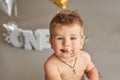 Smash cake party. Little cheerful birthday boy with first cake. Happy infant baby celebrating his first birthday. Decoration and Royalty Free Stock Photo