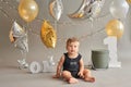 Smash cake party. Little cheerful birthday boy with first cake. Happy infant baby celebrating his first birthday. Decoration and Royalty Free Stock Photo