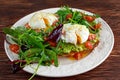 Smashed avocado and poached egg toast on green salad for breakfast Royalty Free Stock Photo