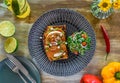 Smashed avocado with poached eggs, red pepper pesto and pickle shallot on toast top view Royalty Free Stock Photo