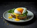 Smashed avocado sandwich with boiled poached egg with flowing yolk and basil leaves. Dark green background