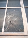 smashed broken window up close criminal damage vandalism crime