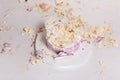 Smashed cake on white table for first birthday. Messy pieces Royalty Free Stock Photo