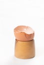 Smashed Egg Shell on the wooden egg holder isolated above white background Royalty Free Stock Photo