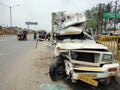 Smashed front end of a pickup truck by a road accident. Head on collision is dangerous for car drivers and passengers.