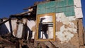 Smashed glass Window with old wooden frame on grunge wall damaged house. Old abandon building. Front facade of an Royalty Free Stock Photo