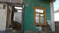 Smashed glass Window with old wooden frame on grunge wall damaged house. Old abandon building. Front facade of an Royalty Free Stock Photo