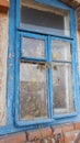 Smashed glass Window with old wooden frame on grunge wall damaged house Royalty Free Stock Photo