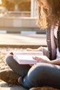 Smb illuminated by the sun reading a book in a big city Royalty Free Stock Photo