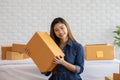 SME entrepreneur of Young Asian women working with laptop for Online shopping at home,Cheerful and Happy with box for packaging in Royalty Free Stock Photo