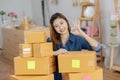 SME entrepreneur of Young Asian women working with laptop for Online shopping at home,Cheerful and Happy with box for packaging in Royalty Free Stock Photo