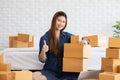 SME entrepreneur of Young Asian women working with laptop for Online shopping at home,Cheerful and Happy with box for packaging in Royalty Free Stock Photo