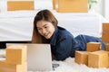 SME entrepreneur of Young Asian women working with laptop for Online shopping at home,Cheerful and Happy with box for packaging in Royalty Free Stock Photo