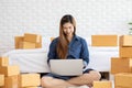 SME entrepreneur of Young Asian women working with laptop for Online shopping at home,Cheerful and Happy with box for packaging in Royalty Free Stock Photo