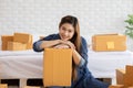 SME entrepreneur of Young Asian women working with laptop for Online shopping at home,Cheerful and Happy with box for packaging in Royalty Free Stock Photo