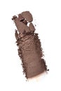 Smear of crushed brown eyeshadow as sample of cosmetic product