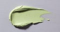 A smear of light green creamy substance spread on a textured surface. The Royalty Free Stock Photo