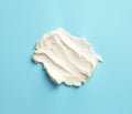 Smear of tasty cream cheese on color background